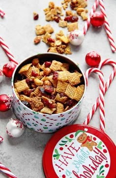 a bowl filled with christmas treats next to candy canes