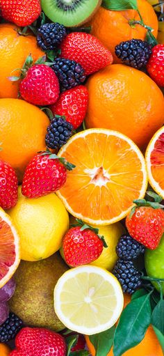 an assortment of fruits including oranges, strawberries and lemons