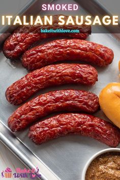 some sausages are on a tray with dipping sauce in front of them and the words, smoked italian sausage