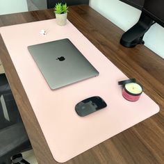 an apple computer sitting on top of a pink desk