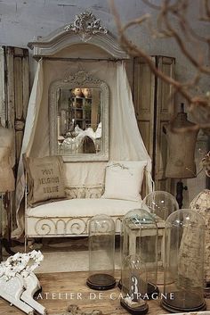 an old fashioned bedroom with antique furniture and mirrors