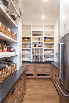 an instagram photo of a kitchen with lots of shelves and drawers on the wall