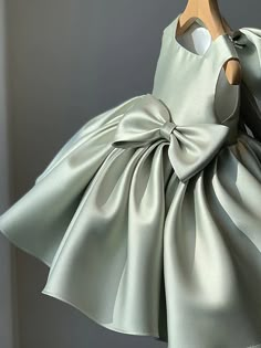 a dress on a mannequin with a bow at the back