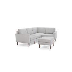 a white couch and ottoman sitting next to each other