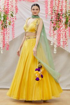 Yellow organza lehenga with embroidered waistband.  Comes with embroidered blouse and green soft net dupatta.
Component: 3
Pattern: Embroidered
Type Of Work: Mirror work
Neckline: V Neck
Sleeve Type: Sleeveless
Fabric: Blouse:Satin; Lehenga:Organza; Dupatta:Soft Net
Color: Yellow
Other Details: 
Side tassel tie-up lehenga
Occasion: Mehendi and Haldi - Aza Fashions Floor-length Organza Sets For Diwali, Luxury Organza Floor-length Sets For Diwali, Festival Organza Sets, Organza Gown With Pallu For Festivals, Yellow Organza Sets For Navratri, Festive Organza Sets, Floor-length, Festive Floor-length Organza Sets, Semi-stitched Organza Sets For Navratri, Yellow Organza Choli With Dori Work