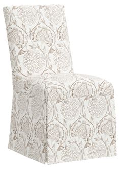 an upholstered chair with a flower pattern on it