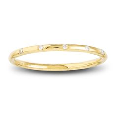 a yellow gold ring with three diamonds