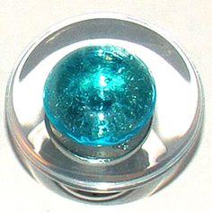 a close up of a glass knob on a white surface