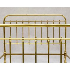 a gold metal bed frame with four posts