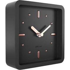 a black square clock with pink hands and numbers on the face that reads nine o'clock