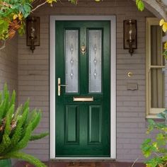 a green front door with two glass panels