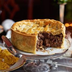 there is a pie on the plate with one slice cut out and ready to be eaten