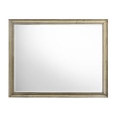 a large mirror on a white wall with a wooden frame and silver trimmings