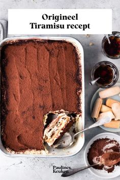 an overhead view of a cake in a pan with chocolate and marshmallows on the side