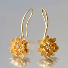 Gold Earrings - Small 18kt waterlilies are fixed on a gracefully-curved gold wire that forms into a gold ear wire.  Originally crafted from sterling silver sheet, they have been cast in gold and finished with a satin texture.  Liquid dip is recommended to maintain the bright luster. Delicate Sterling Silver Yellow Gold Earrings, Gold Floral Earrings With Lever Back, Delicate Handmade Yellow Gold Earrings, Delicate Yellow Gold Pierced Flower Earrings, Elegant Flower Shaped Earrings With French Hook, Yellow Gold Drop Earrings With Flower Design, Pierced Yellow Gold Flower Earrings In Sterling Silver, Elegant Floral Earrings With French Hook, Yellow Gold Sterling Silver Pierced Flower Earrings