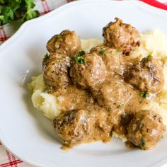 some meatballs and mashed potatoes on a white plate