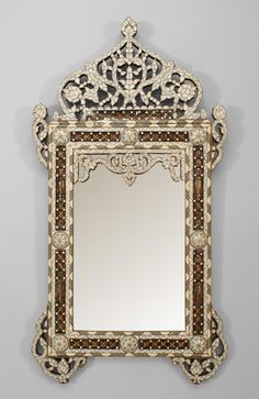 an ornate mirror is hanging on the wall