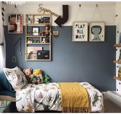 a bed room with a neatly made bed and pictures on the wall