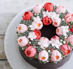 a cake decorated with flowers on top of a white plate