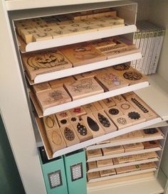 several wooden boxes are stacked on top of each other in a bookcase with drawers