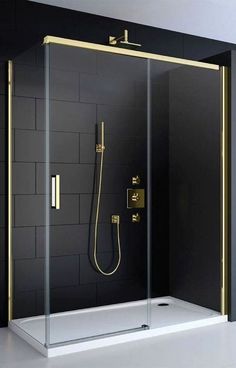 a walk in shower sitting next to a black wall