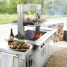 an outdoor grill with food cooking on it