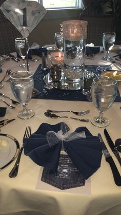 the table is set with silverware and place settings