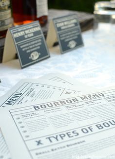 some type of menu sitting on top of a table next to bottles of wine and glasses