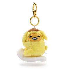 a small stuffed animal sitting on top of a white cloud with a keychain hanging from it's side