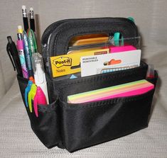 a black bag filled with lots of pens and pencils