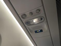 the inside of an airplane looking down at the ceiling and light on it's side