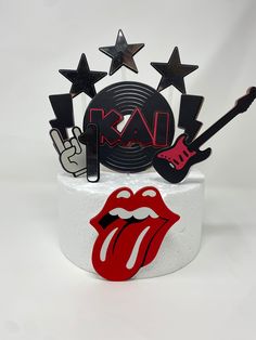 a rolling stones cake with the rolling stones on top and stars around it that say rock n roll