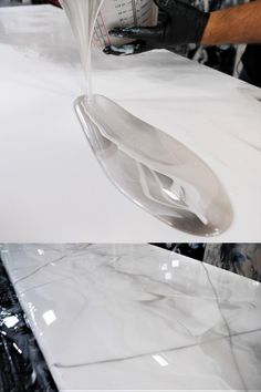 a person pouring liquid onto a white counter top