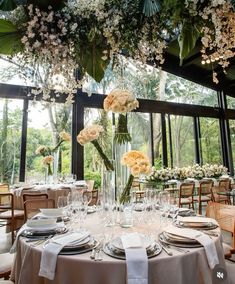 a table set with flowers and place settings