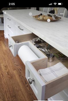 an open drawer in the middle of a kitchen counter