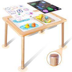 a child's wooden table with an open book on it