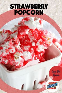 a white bowl filled with red and white popcorn