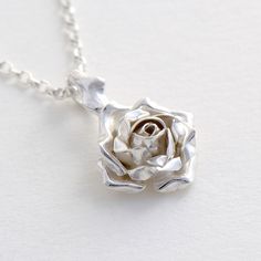 Rose Pendant Necklace, Flower Jewelry, Rose Necklace This exquisite Silver Rose Necklace makes a truly romantic gift! The pendant features a beautiful rose suspended by delicate thorns. * Material: Sterling Silver * Size of Rose: Approx 1 cm (0.4in) diameter * Length of Chain: 40 cm (16in) * Ready to Ship in 2-3 business day * Made in the United Kingdom PACKAGING: Comes uniquely packaged in my Magnolia Restrepo Style Case as shown in the last photo. Additional, I gift wrap all my boxes with gold Rose Shaped Urn Necklace Sterling Silver, Collar Rosa, Rose Pendant Necklace, Anniversary Necklace, Christmas Necklace, Necklace Flower, Prom Jewelry, Rose Gift, Rose Pendant