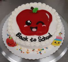 there is a cake with an apple on it that says back to school and has sprinkles around the edges