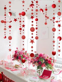 the table is set with pink and red decorations