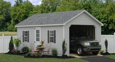 a truck is parked in front of a shed