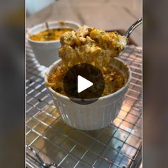 two bowls filled with food sitting on top of a metal rack next to each other