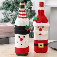 two wine bottles decorated like santa claus and snowman