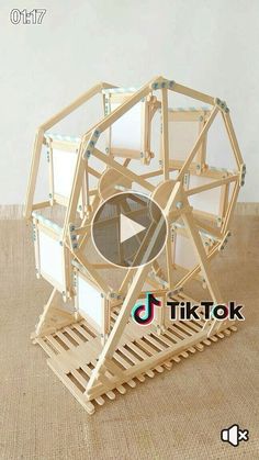 a wooden structure that is on the floor with an object in it's center