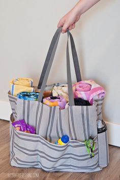 a person is holding a bag full of items on the floor with their hand in it