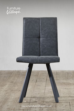 a grey leather chair sitting on top of a wooden floor