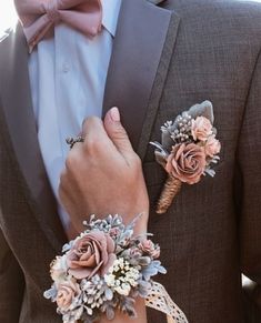 a man in a tuxedo with two boutonnieres on his lapel