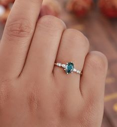 a woman's hand with a diamond and blue topazte ring on it