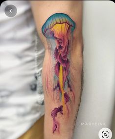 a colorful jellyfish tattoo on the arm