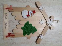 a wooden sled with snowmen and trees on it